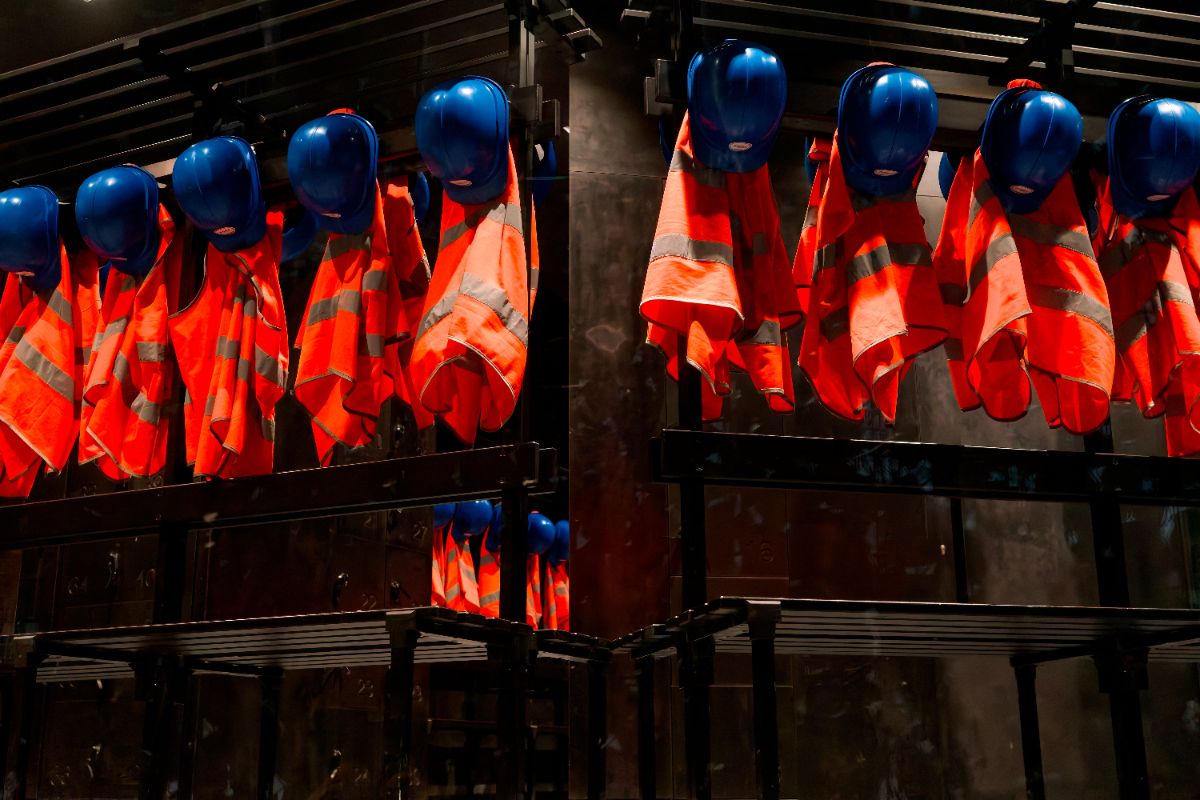 Safety equipment storage with helmets, coveralls and boots